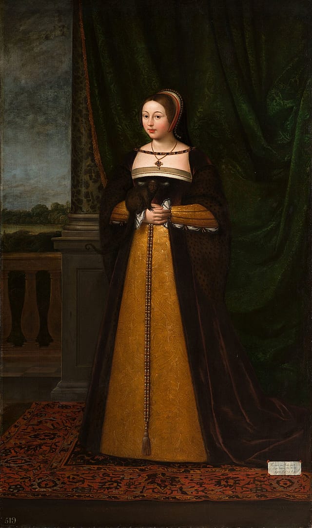 Full-length portrait of a woman in front of a green velvet curtain. To her right is a column and a balcony from which there is a view of a green landscape on an overcast day. The woman is wearing a long gold and brown dress with a necklace and headpiece.