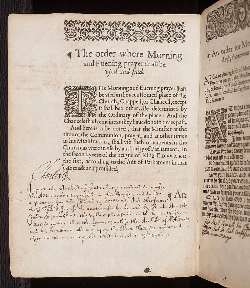 Page from an old book. The top half of the page has printed text and a decorative border. Beneath the text are lines of handwriting in brown ink and the signature of King Charles I.