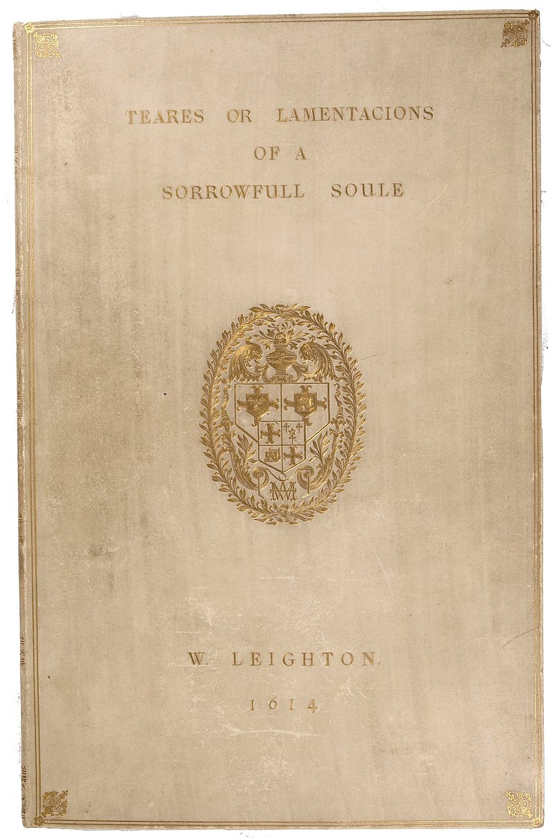 Cover of a slim book bound in disoloured vellum. The vellum was once cream or white. Stamped in gold on the cover are the words 'The teares or lamentacions of a sorrovvfull soule. W. Leighton. 1614'. In the centre of the cover is a stamped elaborate coat of arms. The coat of arms contains the monogram 'W.M'.