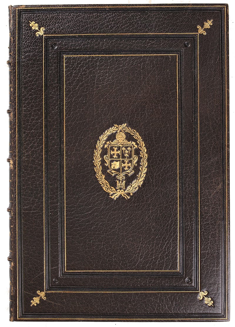 Cover of book bound in browm vellum. In the centre of the cover there is a stamped, gold, elaborate coat of arms. The coat of arms contains the monogram 'W.M'. Three, distinct gold borders surround the coat of arms.