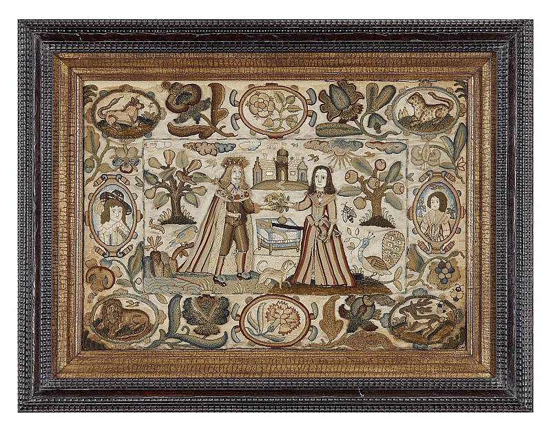 An old, discoloured tapestry depciting a king and a queen standing in a landscape with a castle in the background. Surrounding them are icons of flora and fauna and two portraits of a man and a woman in ovals.
